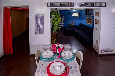a dining table with plates and dishes on it in a living room at Center House Colosseo in Rome