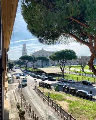 a view of a street with cars parked on the road at Basilica Papale di San Paolo Appartamento Moderno - YOURhOME in Rome