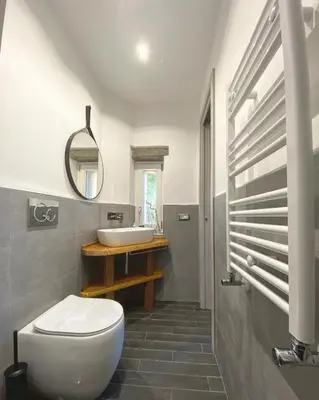 a bathroom with a white toilet and a sink at Basilica Papale di San Paolo Appartamento Moderno - YOURhOME in Rome