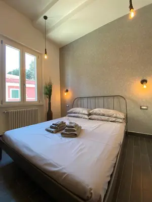 a bedroom with a bed with towels on it at Basilica Papale di San Paolo Appartamento Moderno - YOURhOME in Rome
