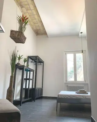 a white room with a bed and a mirror at Basilica Papale di San Paolo Appartamento Moderno - YOURhOME in Rome