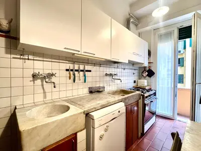 a kitchen with a sink and white cabinets at Casa Pinturicchio in Rome