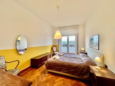 a bedroom with a large bed and a mirror at Casa Pinturicchio in Rome