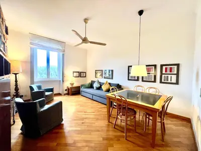 a living room with a table and a blue couch at Casa Pinturicchio in Rome