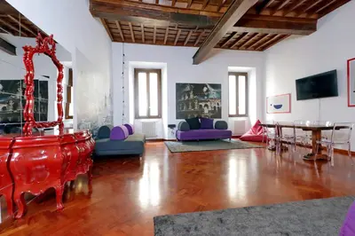 a large living room with a table and chairs at Campo dei Fiori Giubbonari Amazing in Rome
