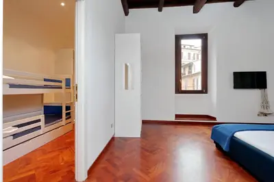 a bedroom with white walls and a bed and a window at Campo dei Fiori Giubbonari Amazing in Rome