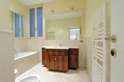a bathroom with a sink and a tub and a mirror at Campo dei Fiori Giubbonari Amazing in Rome