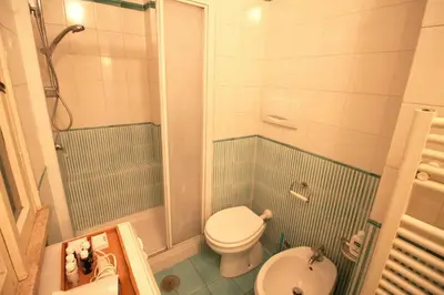 a bathroom with a shower with a toilet and a sink at Family 2BR Apartment in Via Giulia in Rome