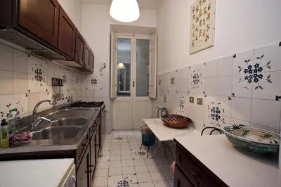 a kitchen with a sink and a counter top at Family 2BR Apartment in Via Giulia in Rome