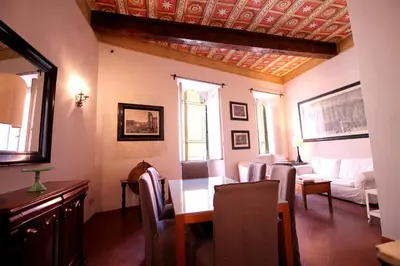 a living room with a table and a couch at Family 2BR Apartment in Via Giulia in Rome