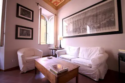 a living room with a white couch and a coffee table at Family 2BR Apartment in Via Giulia in Rome