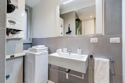 a bathroom with a sink and a washing machine at Luxury Trevi Fountain - Your Italian Holidays in Rome