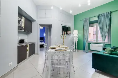 a kitchen and living room with a table and chairs at Luxury Trevi Fountain - Your Italian Holidays in Rome