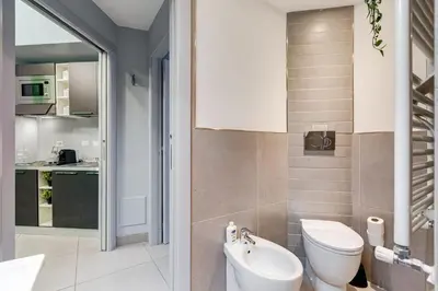 a bathroom with a toilet and a sink at Luxury Trevi Fountain - Your Italian Holidays in Rome