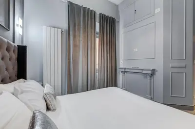 a bedroom with a large white bed and a window at Luxury Trevi Fountain - Your Italian Holidays in Rome