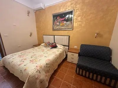 a bedroom with a bed and a chair in it at Marcelina in Rome