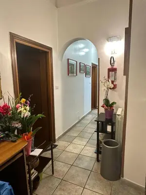 a hallway with flowers and plants in a room at Marcelina in Rome