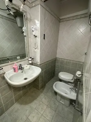 a bathroom with a sink and a toilet and a mirror at Marcelina in Rome