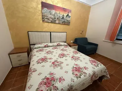 a bedroom with a bed and a blue chair at Marcelina in Rome