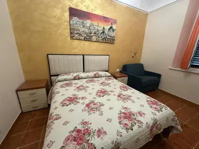 a bedroom with a bed and a blue chair at Marcelina in Rome