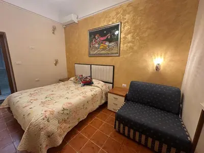 a bedroom with a bed and a chair in it at Marcelina in Rome