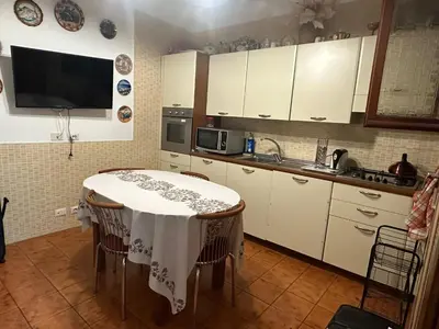 a kitchen with a table and a microwave at Marcelina in Rome
