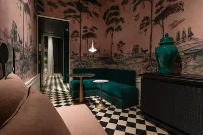 a living room with a green couch and a table at Casa Morgana - The Pantheon Balcony Suite in Rome