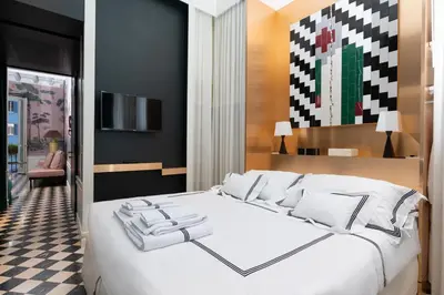 a bedroom with a large white bed with black walls at Casa Morgana - The Pantheon Balcony Suite in Rome