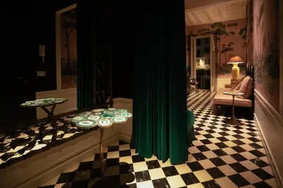 a living room with green curtains and a checkered floor at Casa Morgana - The Pantheon Balcony Suite in Rome