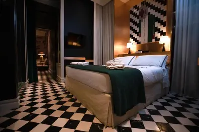 a bedroom with a bed and a checkered floor at Casa Morgana - The Pantheon Balcony Suite in Rome