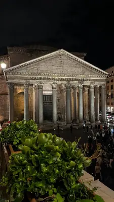 a plant in front of a building at night at Casa Morgana - The Pantheon Balcony Suite in Rome