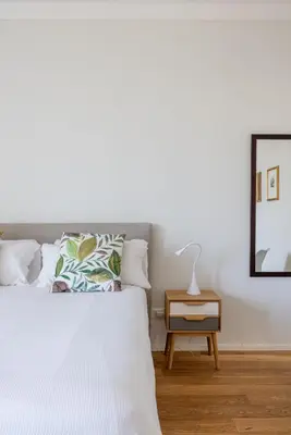 a bedroom with a white bed and a mirror at Top Floor Apt with Rooftop Terrace near St. Peter in Rome