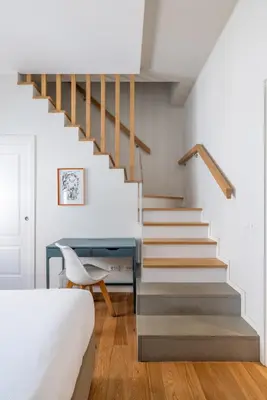 a bedroom with a staircase with a desk and a chair at Top Floor Apt with Rooftop Terrace near St. Peter in Rome