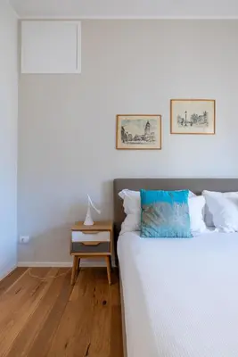 a bedroom with a bed and a side table with a night stand at Top Floor Apt with Rooftop Terrace near St. Peter in Rome