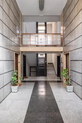 an empty lobby with stairs and potted plants at Top Floor Apt with Rooftop Terrace near St. Peter in Rome