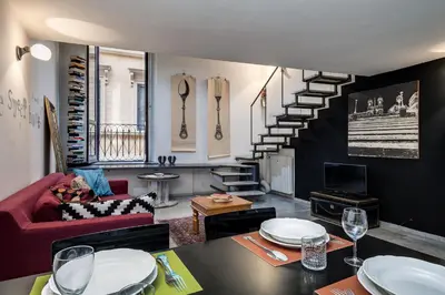 a living room with a red couch and a staircase at Rome Loft in Rome