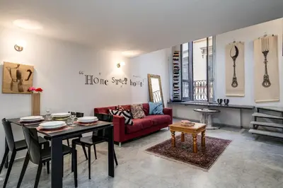 a living room with a red couch and a table at Rome Loft in Rome
