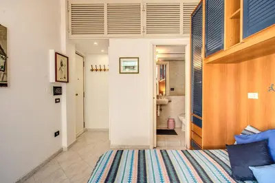 a bedroom with a bed and a bathroom at Apartment Bentivoglio in Rome