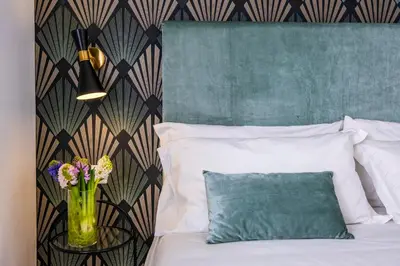 a bedroom with a bed with a vase of flowers at The Vista Rooms & Terrace in Rome