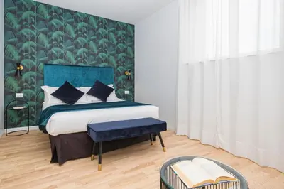 a bedroom with a bed with a green wall at The Vista Rooms & Terrace in Rome