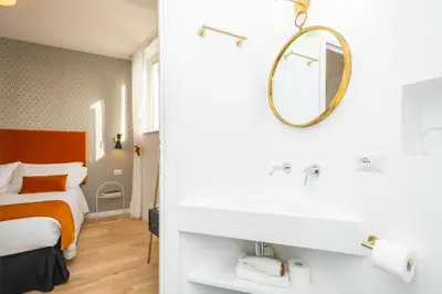 a bedroom with a bed and a mirror at The Vista Rooms & Terrace in Rome