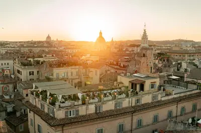 an aerial view of a city at sunset at The Vista Rooms & Terrace in Rome