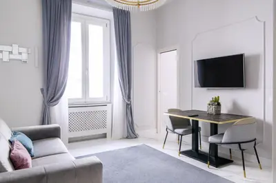 a living room with a table and a couch at Rome Deluxe Apartments in Rome