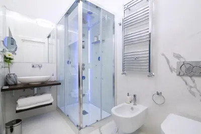 a bathroom with a glass shower and a sink at Rome Deluxe Apartments in Rome
