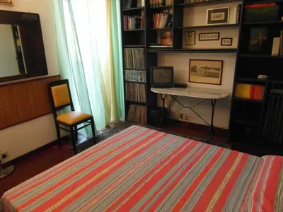 a room with a library with a table and a desk at Abitazione Pigneto B&B in Rome