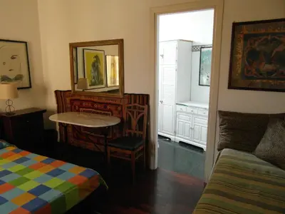a bedroom with a table and a mirror and a bed at Abitazione Pigneto B&B in Rome