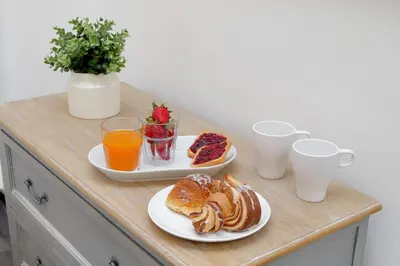 a table with two plates of breakfast foods and drinks at Urbana Delicious Flat in Rome