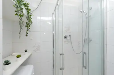 a white bathroom with a shower and a toilet at Urbana Delicious Flat in Rome