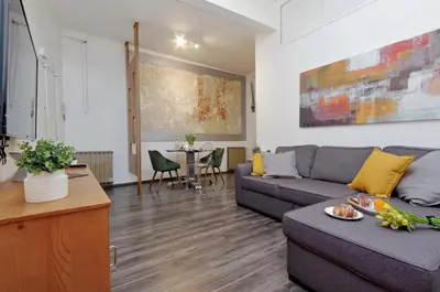 a living room with a couch and a table at Urbana Delicious Flat in Rome