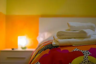 a pile of towels sitting on top of a bed at On The Rainbow B&B in Rome